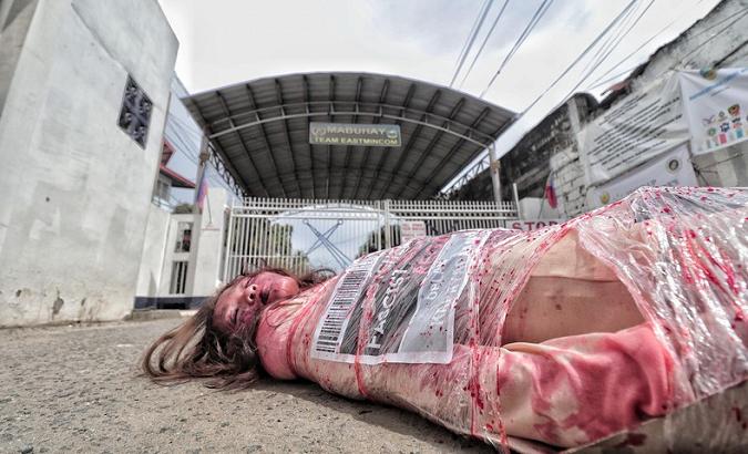 Protesters hold a staged 'die-in' demonstration during the Human Rights Rally in the Philippines.