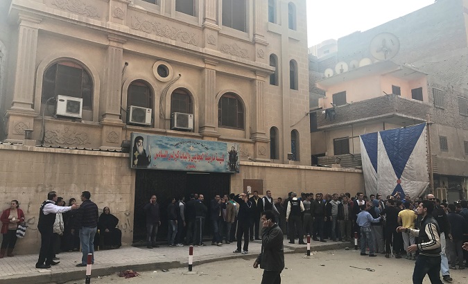 People are seen outside the Mar Mina Church after a blast, in Helwan district on the outskirts of Cairo, Egypt Dec. 29, 2017