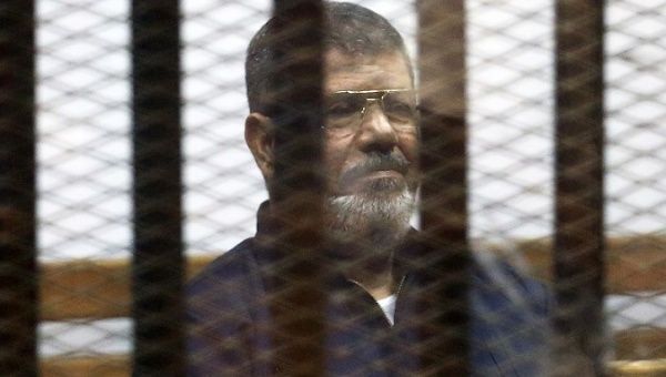 Deposed Egyptian President Mohammed Morsi listens to his verdict behind bars at a court on the outskirts of Cairo, Egypt June 16, 2015.