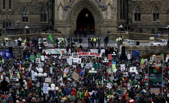 Protesters take part in a rally held a day before the start of the 2015 Paris Climate Change Conference (COP21), on Parliament Hill in Ottawa, Canada, November 29, 2015.