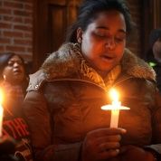 Eric Garner's daughter Erica Garner takes part in candlelight vigil at the site where her father died in July last year after being put in a chokehold, during a Martin Luther King Day service in the Staten Island borough of New York, U.S., Jan. 19, 2015.