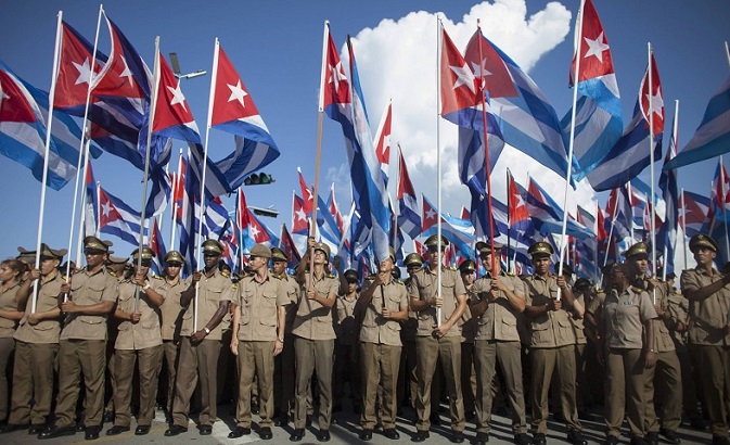 Soldiers wave the Cuban flag during Cuban Revolution commemorations.