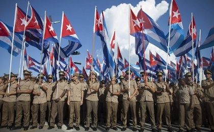Soldiers wave the Cuban flag during Cuban Revolution commemorations.