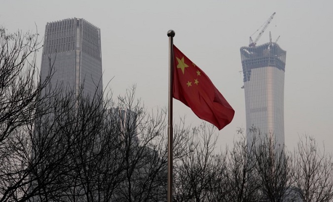 China World Trade Center Tower III (L) and China Zun Tower under construction are pictured behind a Chinese flag in Beijing's central business area, China December 14, 2017.