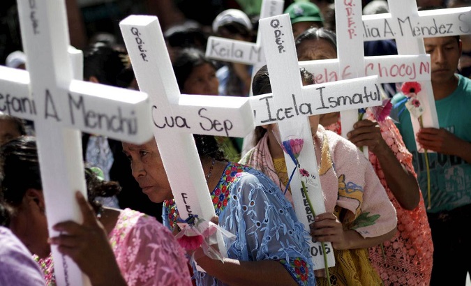 Women hold makeshift crosses during a march to commemorate International Day for the Elimination of Violence Against Women, in Guatemala City.