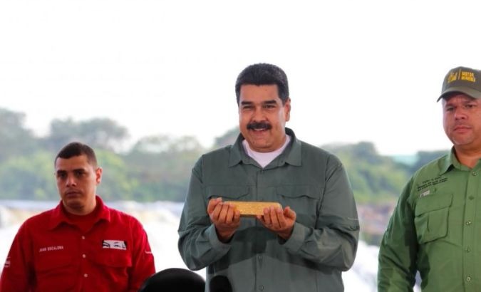 Venezuela's President Nicolas Maduro (Center) holds a gold bar during a meeting with representatives of the mining sector in Puerto Ordaz, Venezuela.