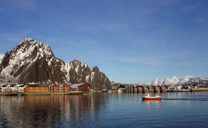 A fishing boat enters the harbor at the Arctic port of Svolvaer in northern Norway, March 2013.