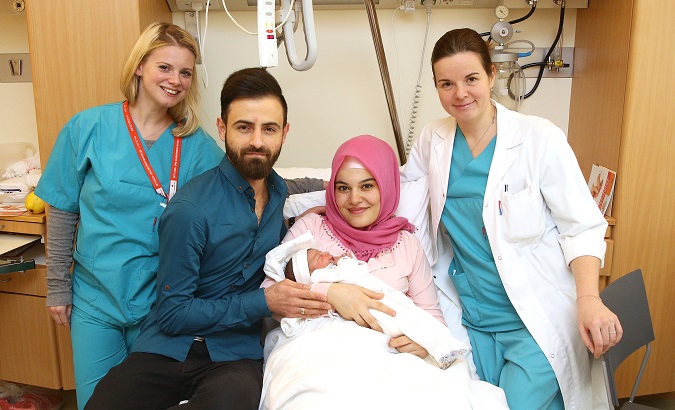 Baby Asel and her parents with medical staff at a hospital in Vienna.