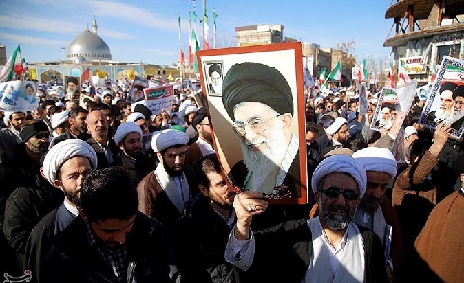 Pro-government counter-protesters hoist pictures of Supreme Leader Ayatollah Ali Khamenei.