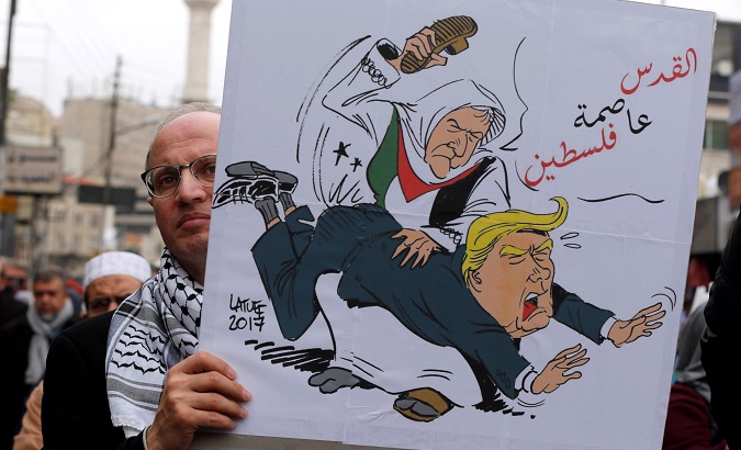 A man holds a placard during a protest against U.S. President Donald Trump's recognition of Jerusalem as Israel's capital, in Amman.