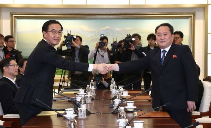 Head of the North Korean delegation, Ri Son Gwon shakes hands with his South Korean counterpart Cho Myoung-gyon during their meeting at the truce village, January 9, 2018.