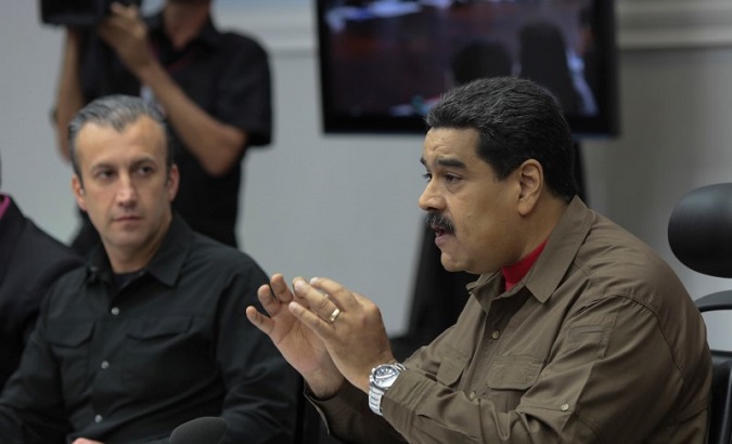 Venezuela's President Nicolas Maduro (R) speaks during a meeting with ministers in Caracas, Venezuela January 5, 2017