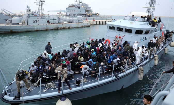 Refugees in a boat arrive at a naval base after they were rescued by Libyan coast guards, in Tripoli, Libya January 9, 2018.