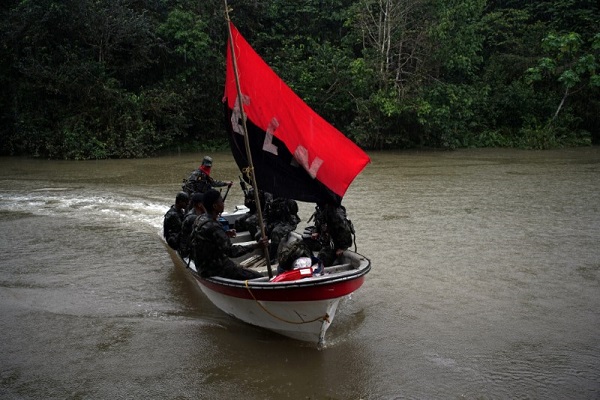 Rebels from Colombia's National Liberation Army in a boat in the northwestern jungles.