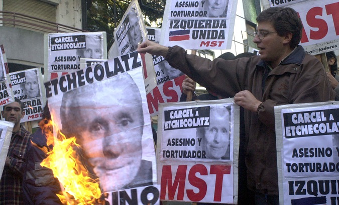 Argentines demand prison for Etchecolatz during 2001 protest in Buenos Aires.
