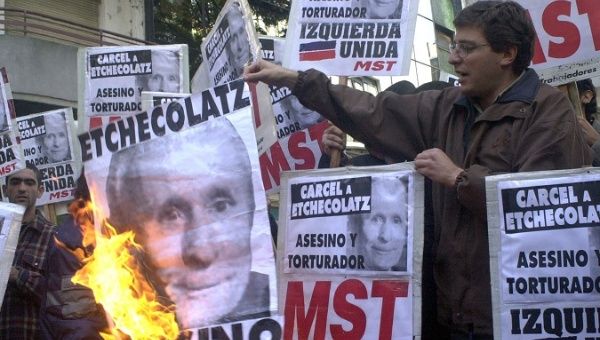 Argentines demand prison for Etchecolatz during 2001 protest in Buenos Aires. 