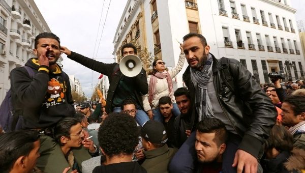 Demonstrating graduate students shout slogans, as riot police stand guard, during protests against rising prices and tax increases, in Tunis, Tunisia January 12, 2018.
