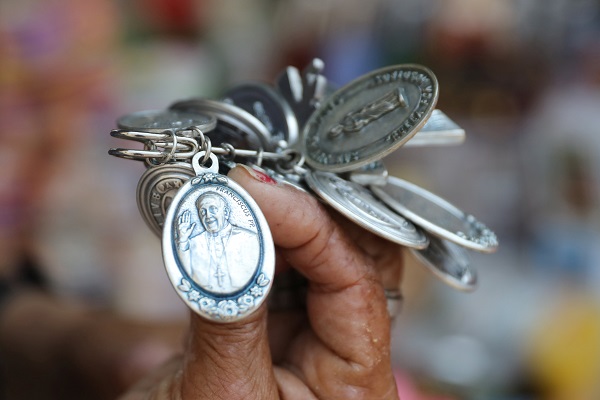 A street vendor shows a souvenir of Pope Francis prior to his visit to Peru from January 18 to 21, in Lima. 