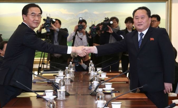 Ri Son-gwon (right), head of the North Korean delegation, shakes hands with his South Korean counterpart Cho Myoung-gyon during their meeting at the truce village of Panmunjom on Tuesday.