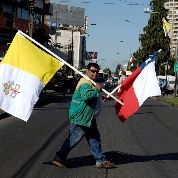 Chilean and Vatican flags are carried by a man ahead of the papal visit in Temuco, Chile.