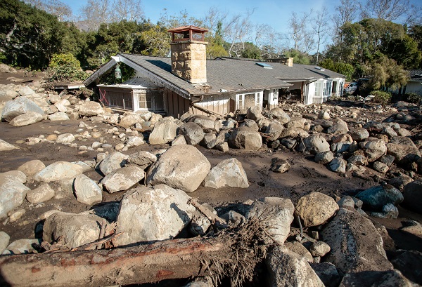 Boulders surround a mud-filled property. Residents in some areas were subject to a new mandatory evacuation on Friday, emergency officials said, adding the unstable environment remained a threat.