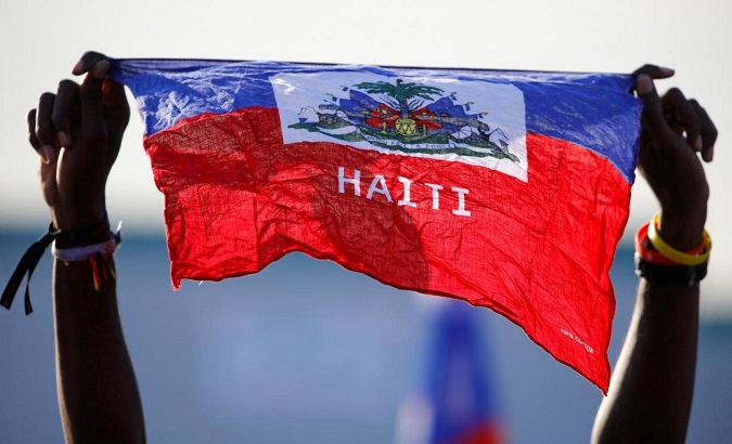 A girl holds national flag of Haiti before Pope Francis' arrival at the Campus Misericordiae during World Youth Day in Brzegi, near Krakow, Poland.