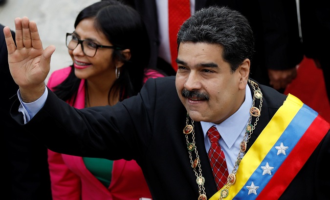 Venezuelan President Nicolas Maduro arrives to give his annual address to the nation, accompanied by Constituent Assembly President Delcy Rodriguez.
