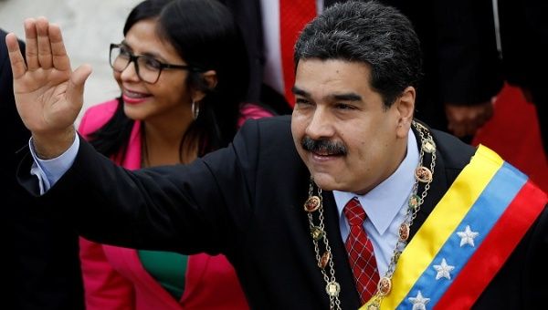 Venezuelan President Nicolas Maduro arrives to give his annual address to the nation, accompanied by Constituent Assembly President Delcy Rodriguez.