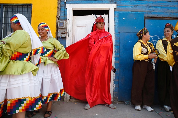 Members of Iquique's Diablada folkloric group take a much-needed break after a rousing rehearsal.