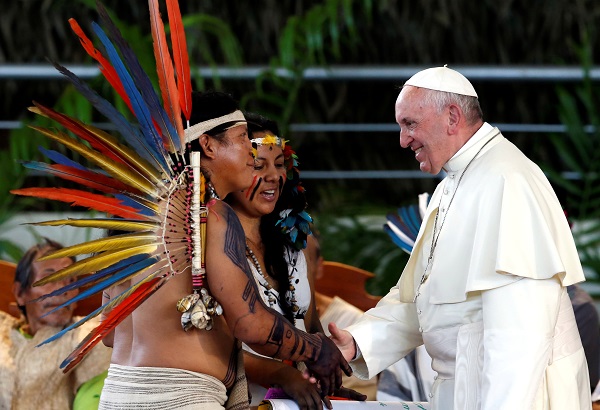 Pope Francis greets members of an Indigenous group from the Amazon region, at the Coliseum Madre de Dios, in Puerto Maldonado, Peru.