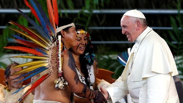 Pope Francis greets members of an Indigenous group from the Amazon region, at the Coliseum Madre de Dios, in Puerto Maldonado, Peru. 