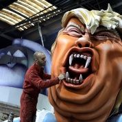 A worker puts the final touches on a giant figure of Donald Trump during preparations for the carnival parade in Nice, France.