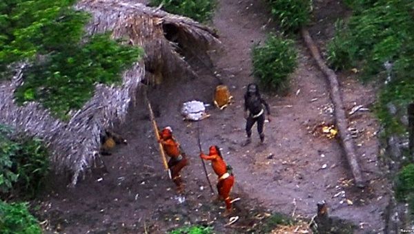Members of an uncontacted Amazon Basin tribe and their dwellings are seen in the Brazilian state of Acre along the border with Peru in 2008.