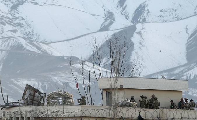 Afghan security forces take position on a roof of a building the site of a blast and gunfire between Taliban and Afghan forces in PD 6 in Kabul.