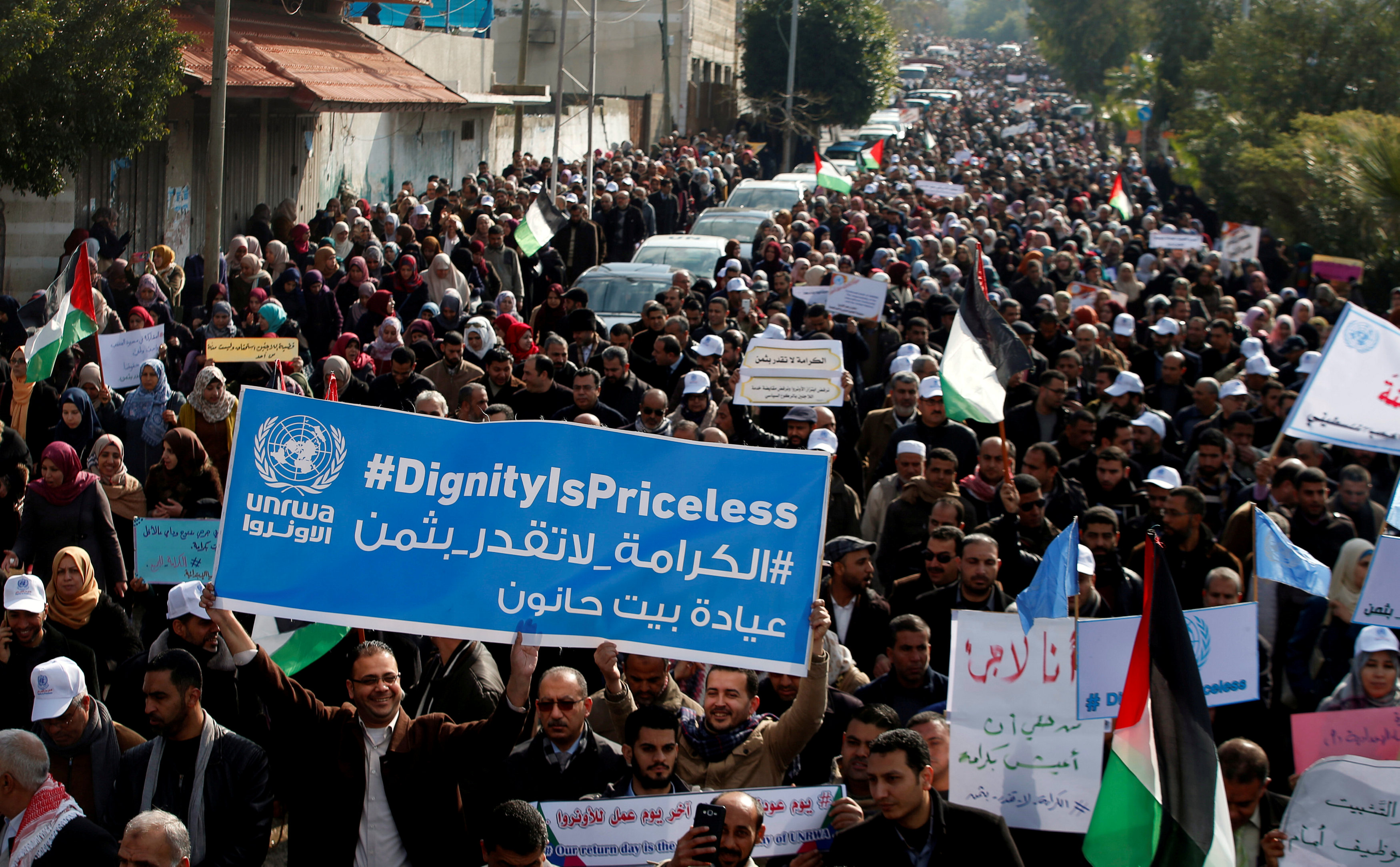 Palestinian employees of United Nations Relief and Works Agency (UNRWA) hold a sign during a protest against a U.S. decision to cut aid, in Gaza City January 29, 2018.
