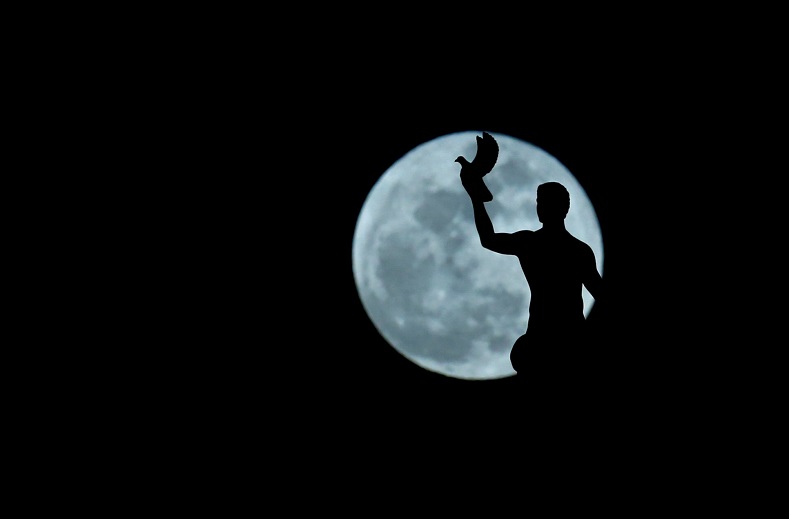 A full moon 'supermoon' rises behind a sculpture at the ministry of foreign affairs in Skopje, Macedonia.
