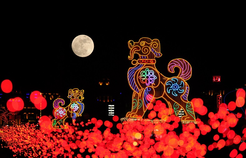 The supermoon is seen behind dog-shaped giant lanterns in Dalian, Liaoning province, China.