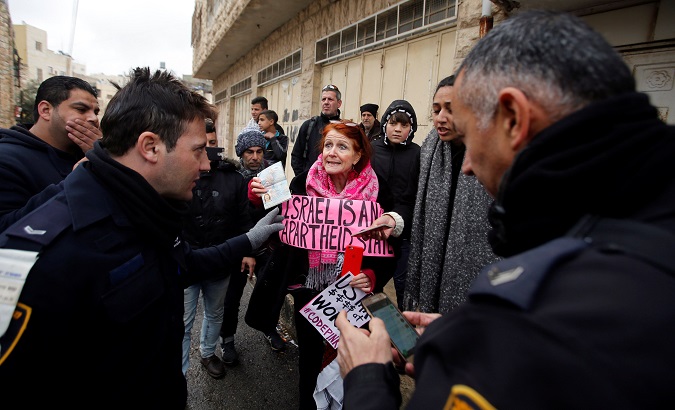 A foreign activist argues with an Israeli police officer during a protest against Jewish settlements in the West Bank city of Hebron Jan. 27, 2018.