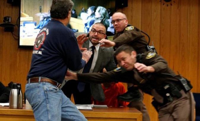 Randall Margraves (left), father of three of Larry Nassar's victims, lunges at the disgraced former Olympics doctor in court.
