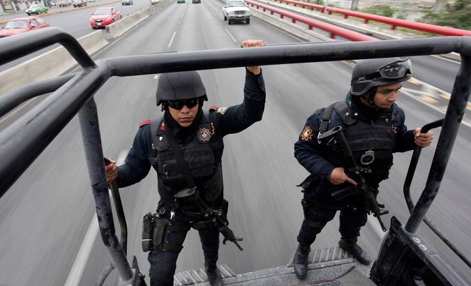 Members of the Fuerza Civil (Civil Force) police patrol during a media presentation in Monterrey, Mexico. Dec. 17, 2014.