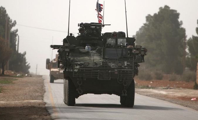 U.S. army vehicles drive north of Manbij city, in Aleppo Governorate, Syria.