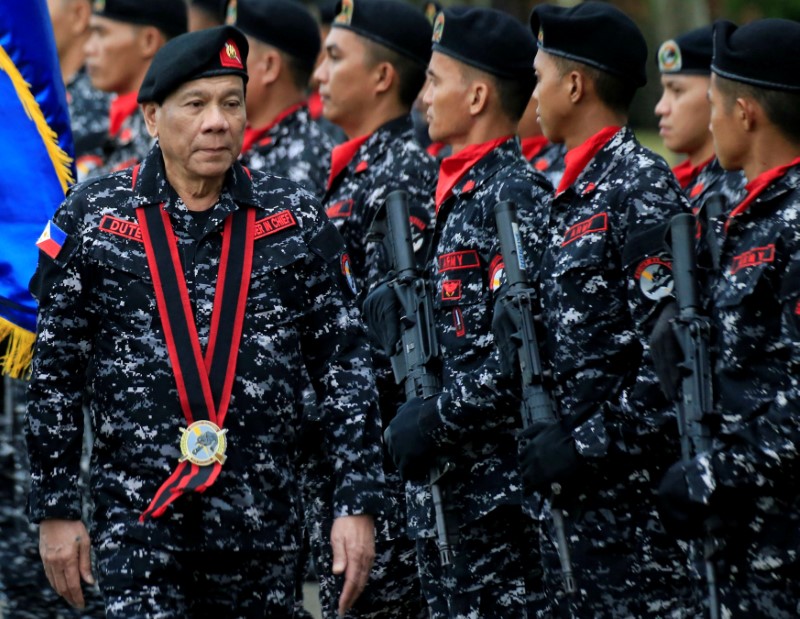 Philippine President Rodrigo Duterte, wearing a military uniform, reviews scout ranger troops upon his arrival during the 67th founding anniversary of the First Scout Ranger regiment in San Miguel town, Bulacan province, north of Manila, Philippines November 24, 2017.