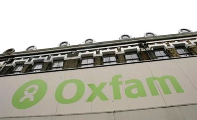 The Oxfam logo is seen on a signage outside a store in Dalston in east London.
