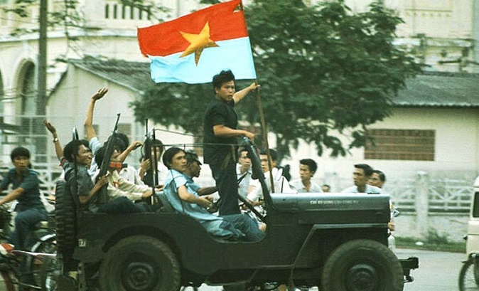 Communist North Vietnamese soldiers celebrate as they enter Saigon, triumphant, in 1975.