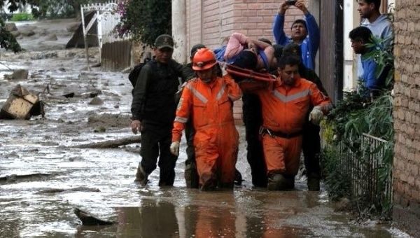 A woman is rescued amid intense floods in Bolivia.