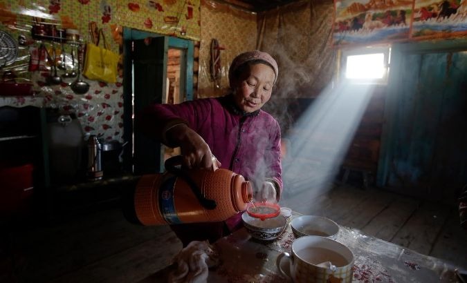 Yonghong, a local villager, prepares buttered tea.