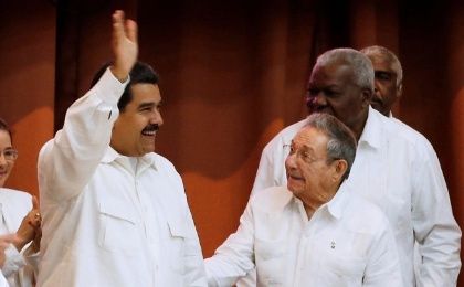 Venezuela's President Nicolas Maduro (L), waves beside Cuba's President Raul Castro at an event in Havana last year.