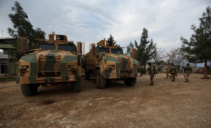 Turkish-backed Free Syrian Army fighters are seen next to military trucks in Northern Afrin countryside, Syria, Feb. 16, 2018.