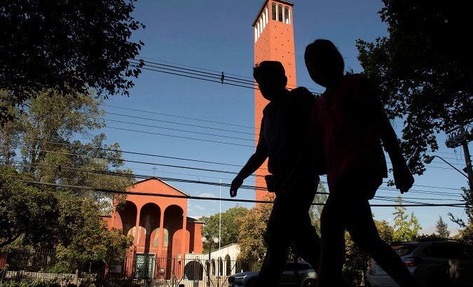 People walks past 'El Bosque' church, former parish of Vatican-convicted child abuser Karadima, in Santiago, Chile.