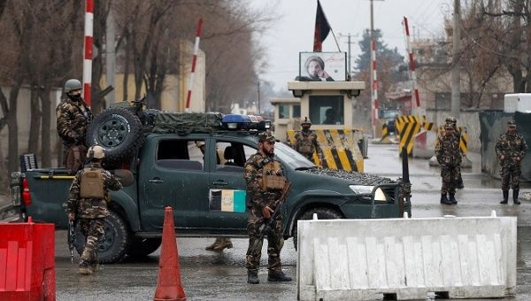 Afghan security forces keep watch at a check point near the site of a suicide attack in Kabul, Afghanistan Feb. 24, 2018. 